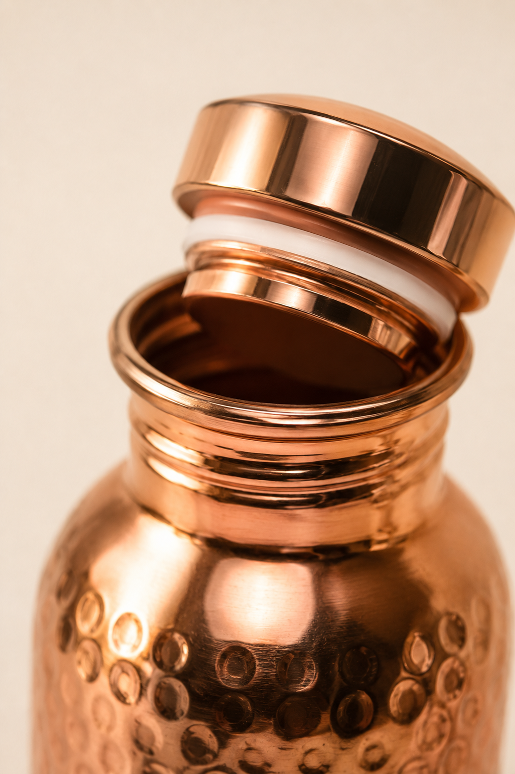 Macro detail of the one-click lid mechanism on the Copper Ritual bottle